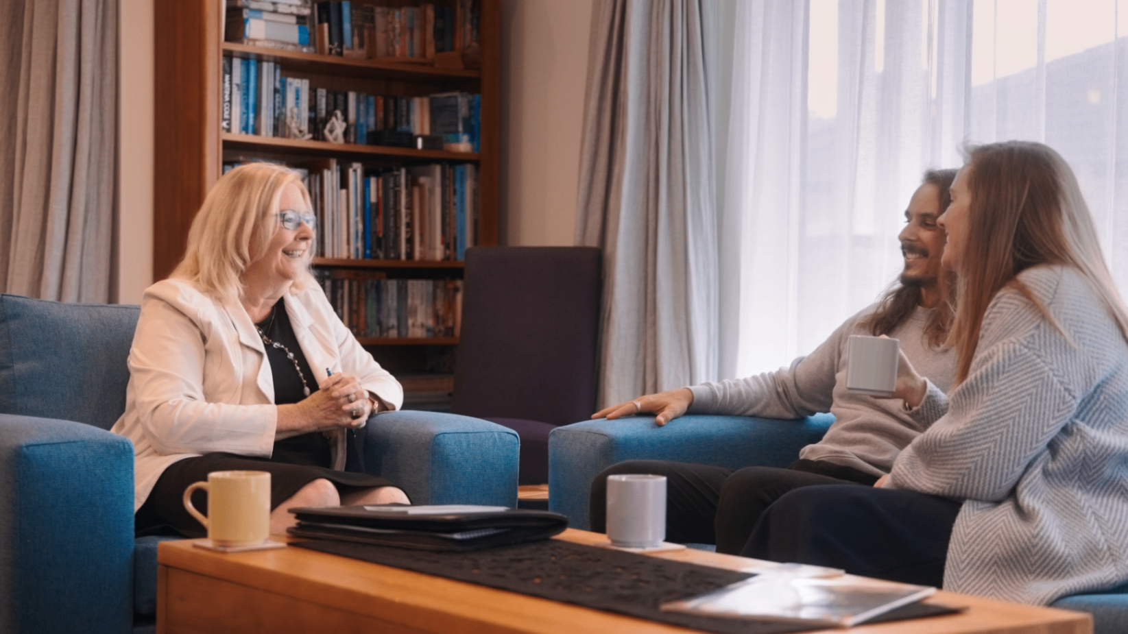 Donna sitting with clients in a lounge conversation